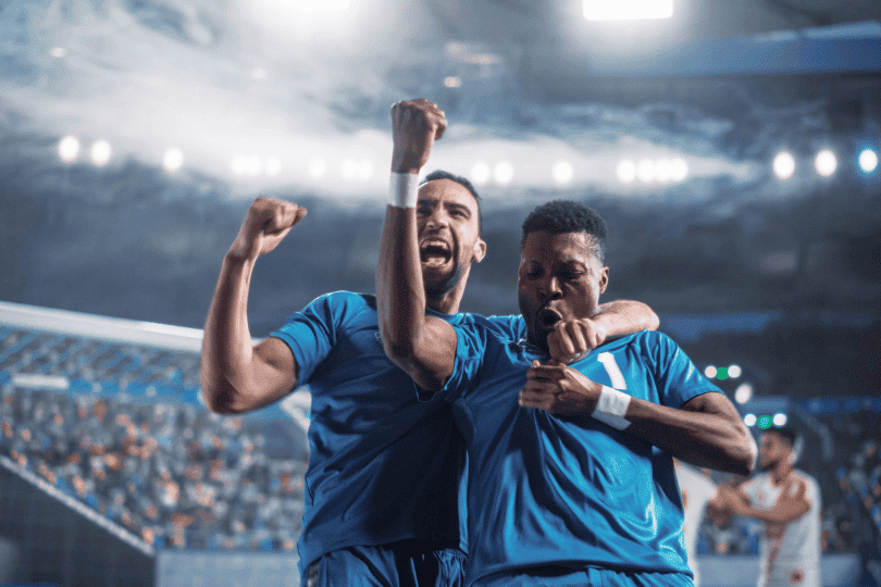 Two football players celebrating a goal